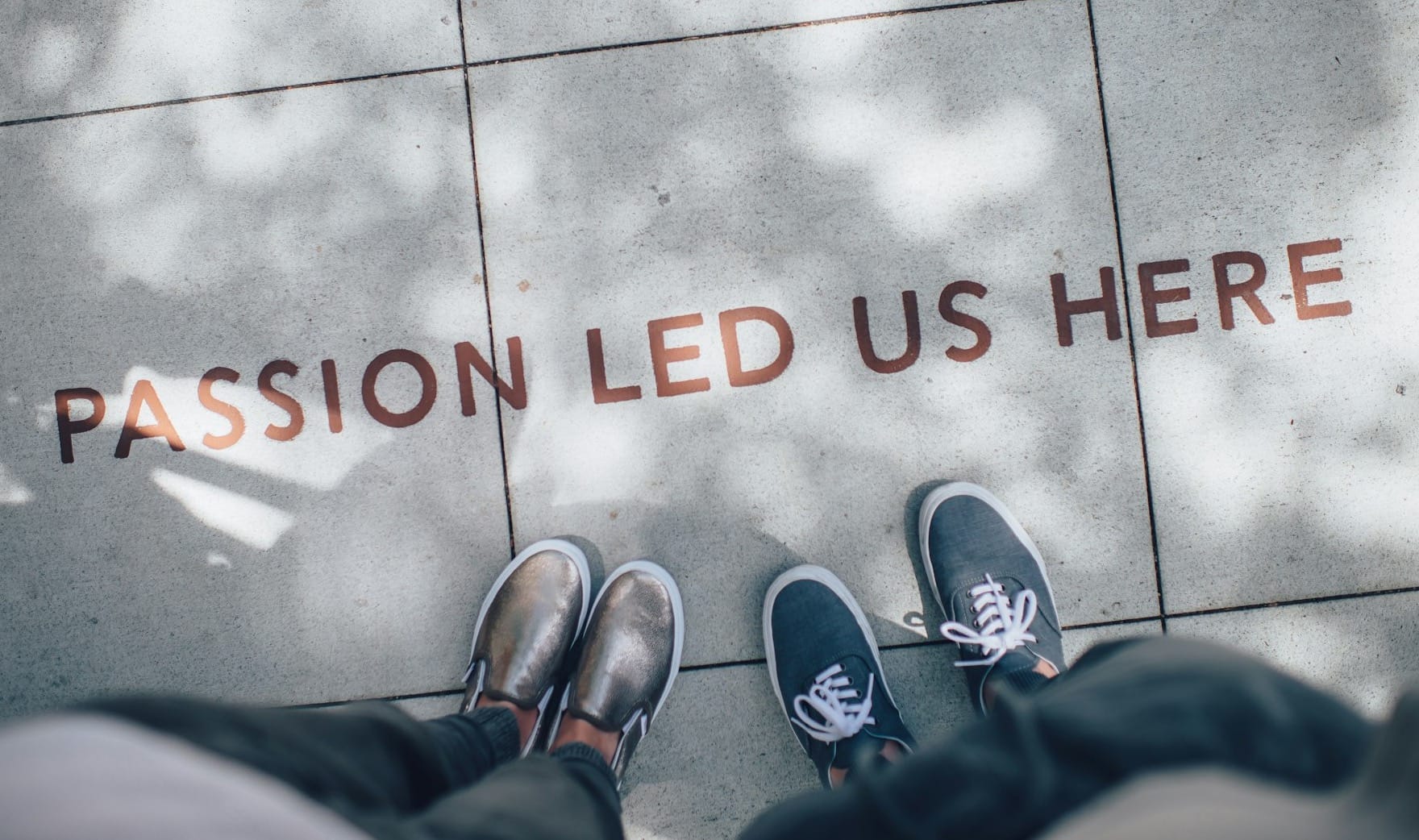 two person standing on gray tile paving